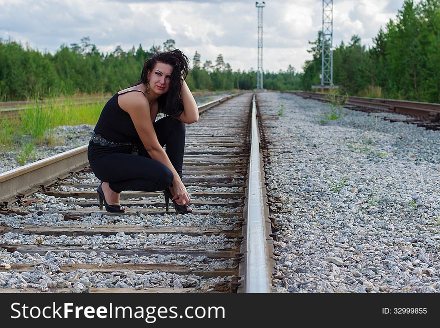 Young Woman Sitting On A Railroad