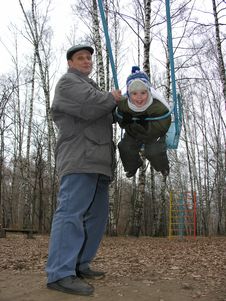 Grandfather With Grandson On Seesaw Stock Photography