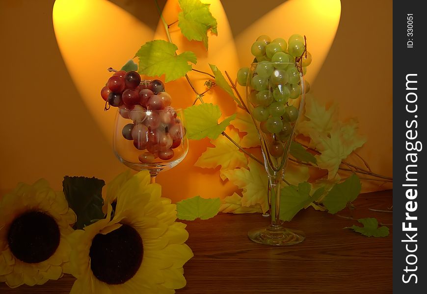 Two glasses filled with grapes with spot. Two glasses filled with grapes with spot.