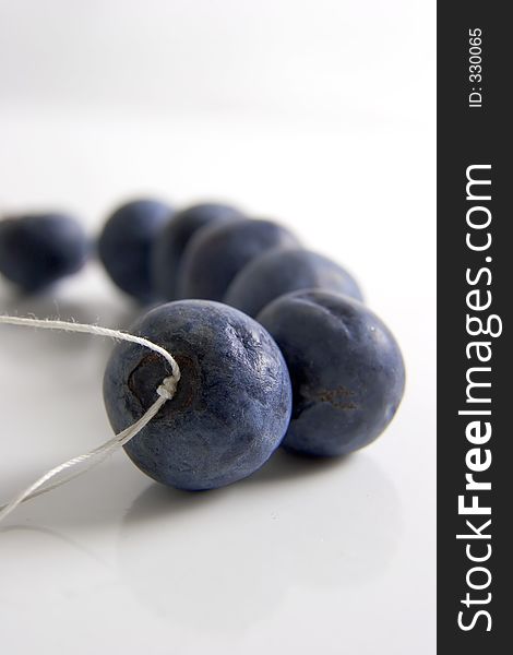 Fresh blueberries on a sting against a white background. Fresh blueberries on a sting against a white background
