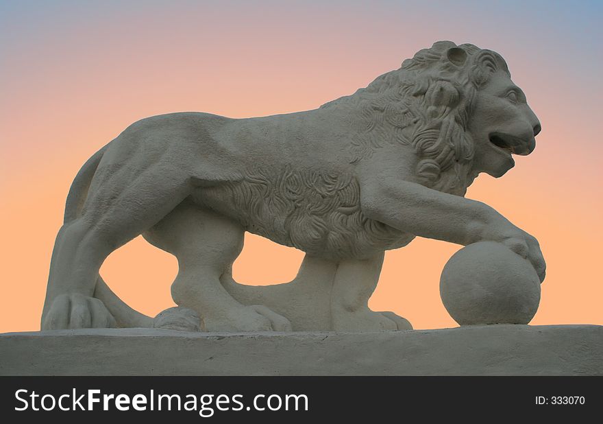 Monument to a lion on a background of a sunset. Monument to a lion on a background of a sunset