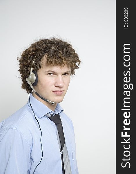 Boy in relaxed business attire wearing a telephone headset. Boy in relaxed business attire wearing a telephone headset.