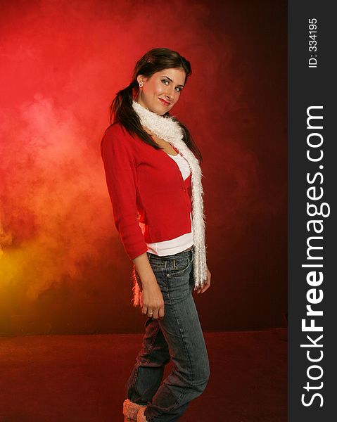 Girl wrapped up in red sweater and white scarf for her walk on red and gold background. Girl wrapped up in red sweater and white scarf for her walk on red and gold background