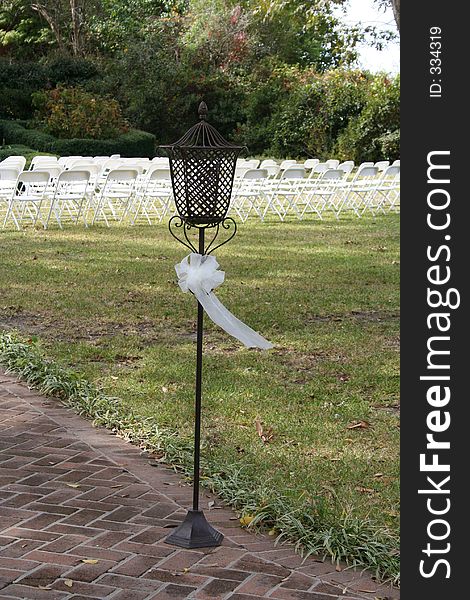 A lamp at the entrance to an outdoor wedding. A lamp at the entrance to an outdoor wedding