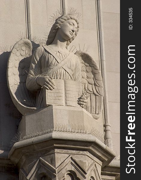 A sandstone angel on the face of a catholic church. A sandstone angel on the face of a catholic church.