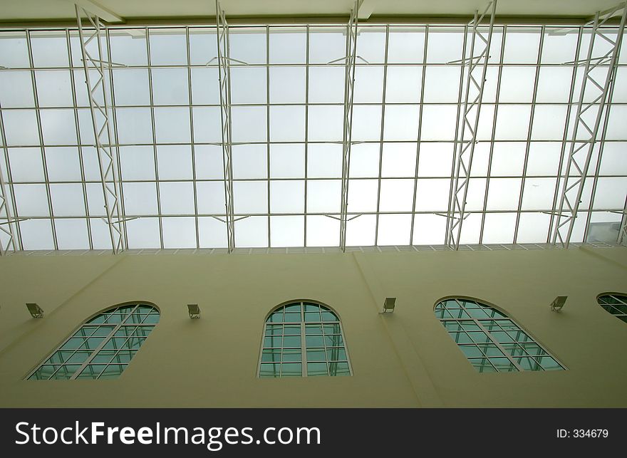 Glass ceiling in a modern open-space interior for ample natural lighting.