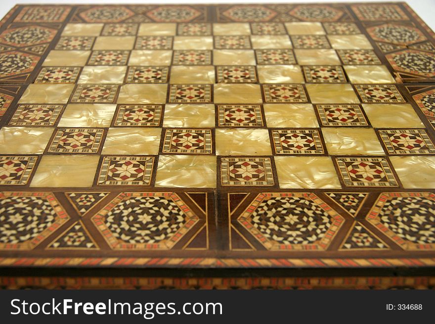 Antique foldable wooden chessboard with 'mother of pearl' squares set in. Antique foldable wooden chessboard with 'mother of pearl' squares set in.