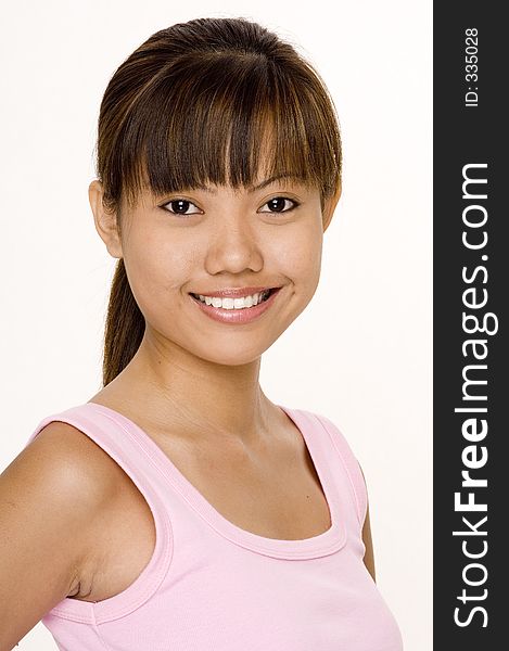 A cute young asian woman in a pink top on white. A cute young asian woman in a pink top on white