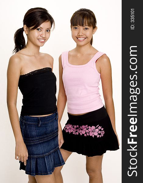 Two pretty young asian girls in casual clothes. Two pretty young asian girls in casual clothes