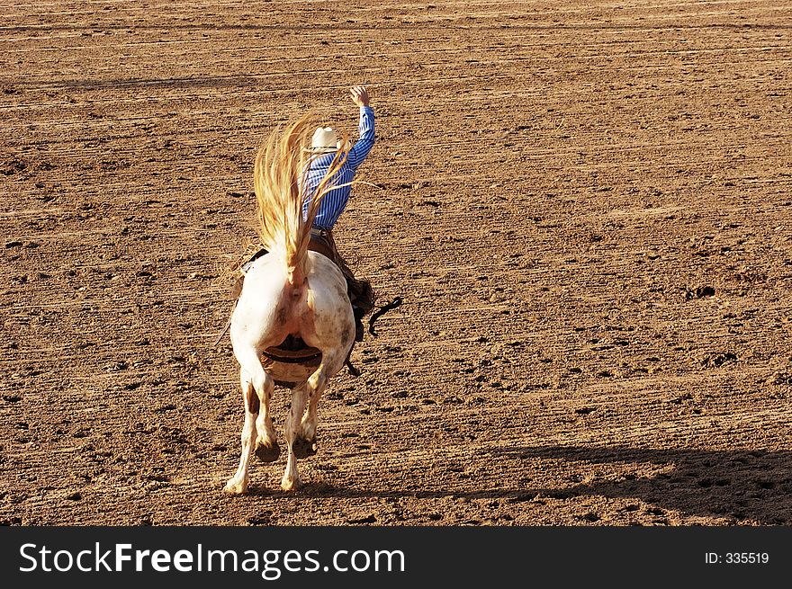 Saddle bronc riding rodeo competition.