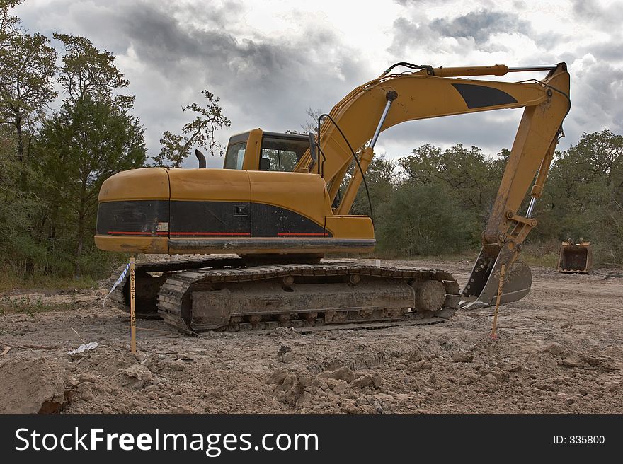 Excavator on dirt pile