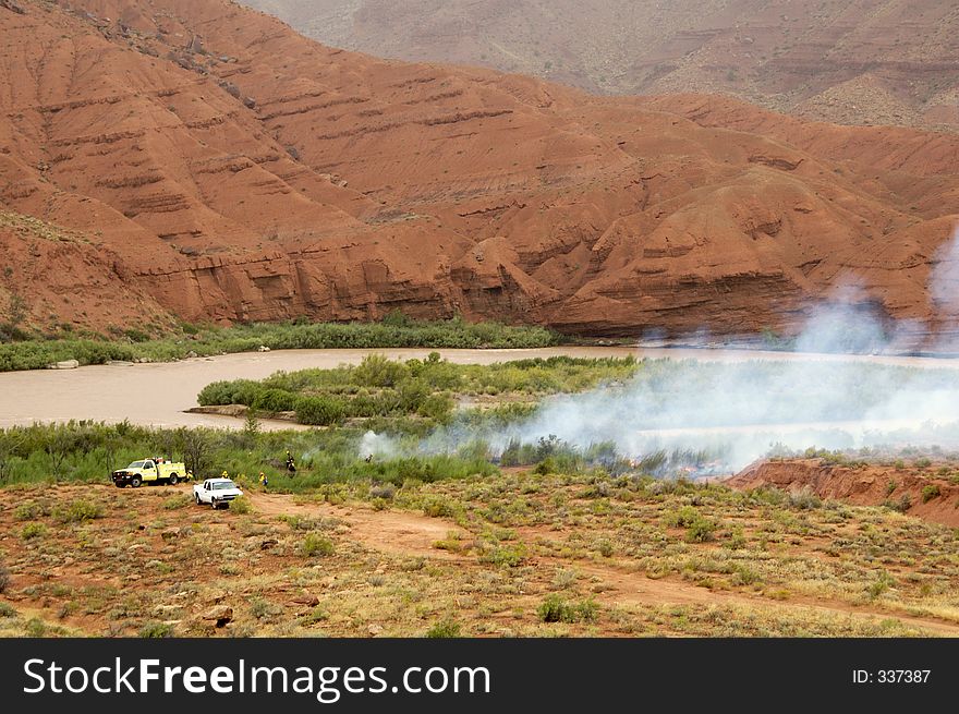 Firemen watch over a prescribed burn on public land in the high desert of Utah.