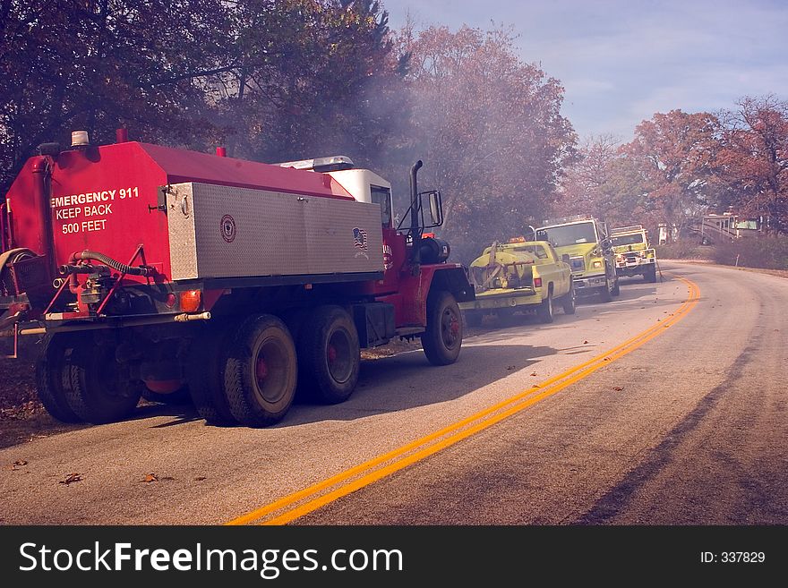 Some fire tenders wating beside the highway while their crews fight a bush fire in the Ozark Mountains. Some fire tenders wating beside the highway while their crews fight a bush fire in the Ozark Mountains