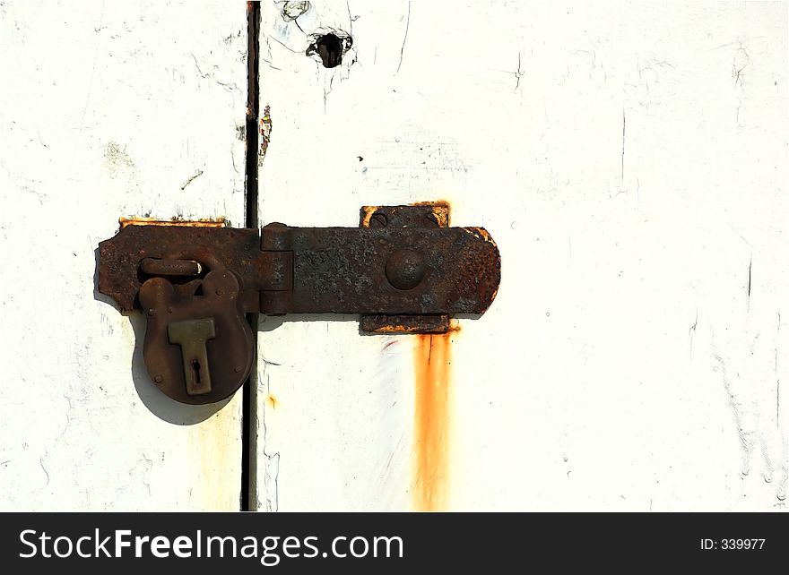 Old door and lock, with rust streaks. Old door and lock, with rust streaks.