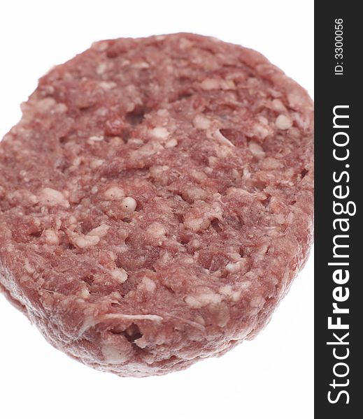 Uncooked raw Beefburger against a white background