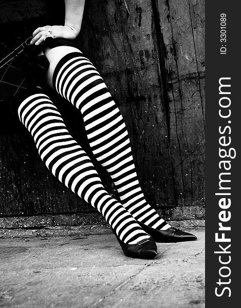 Womans legs with striped stockings in heels. Womans legs with striped stockings in heels