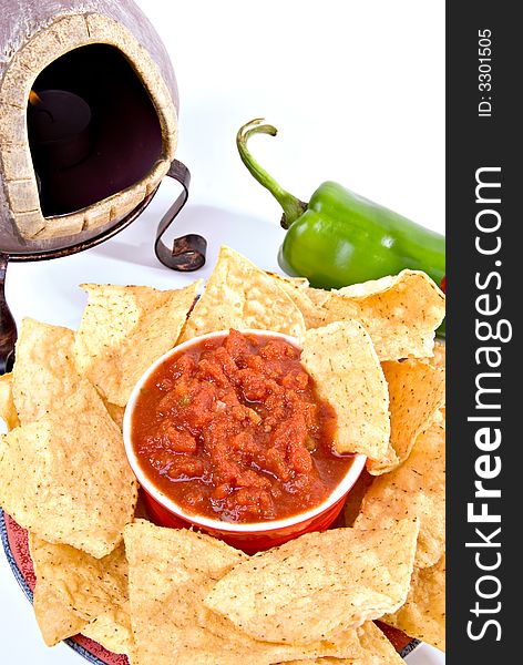 Closeup of tortilla chips and salsa with anaheim pepper and mexican oven. Closeup of tortilla chips and salsa with anaheim pepper and mexican oven