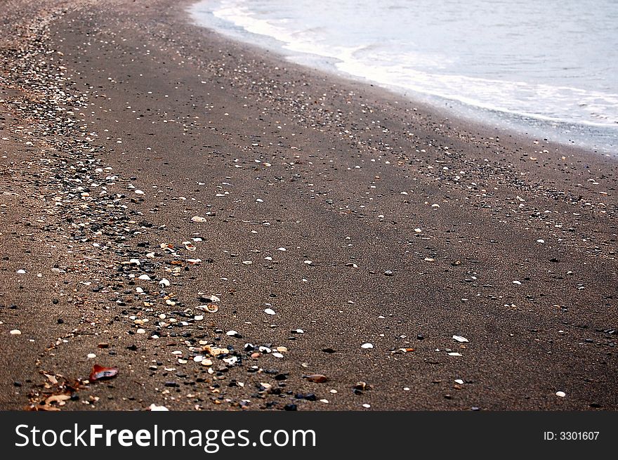 Beach of black sand on the west coast of new caledonia