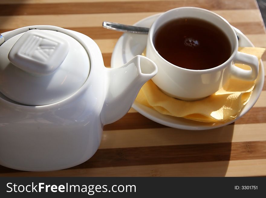 White Brewing teapot with a cup