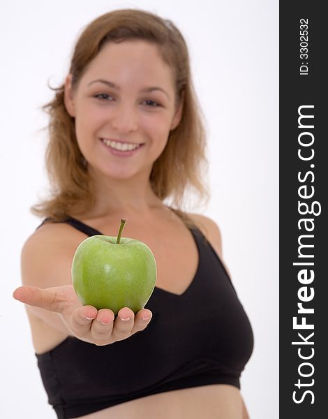 Fitness girl with apple, isolated, focus on the apple