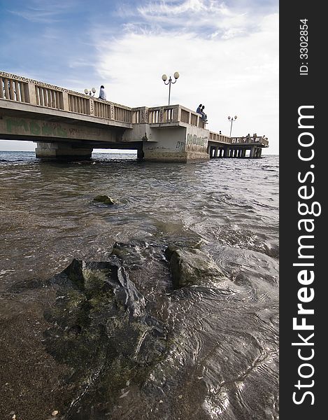 Black stones with landing stage in the background