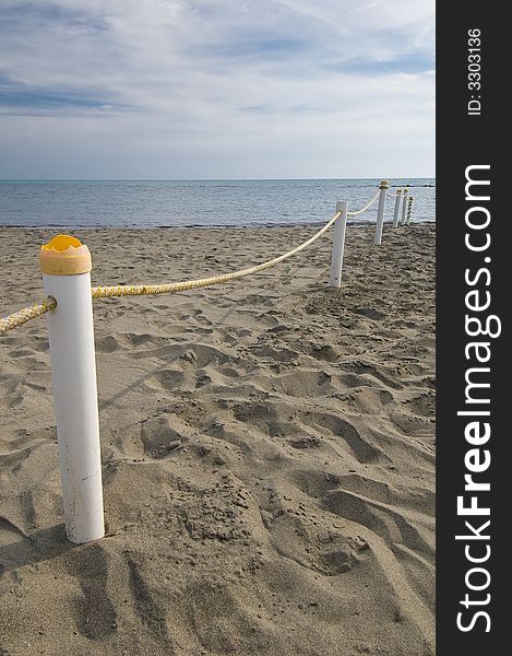 Colorful rope fence on a desolate beach. Colorful rope fence on a desolate beach