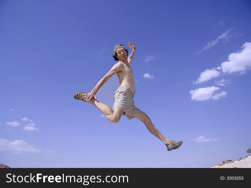 Healthy happy man jumping in joy of life