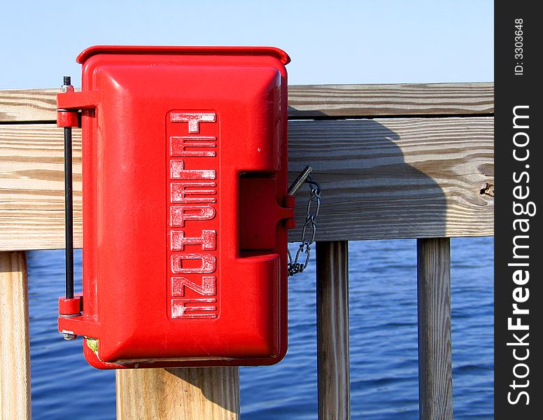 Red emergency telephone and communication channel near lake