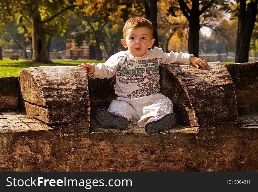 Baby sitting on a log. Baby sitting on a log.