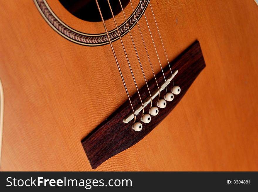 Closeup details of an acoustic wooden guitar