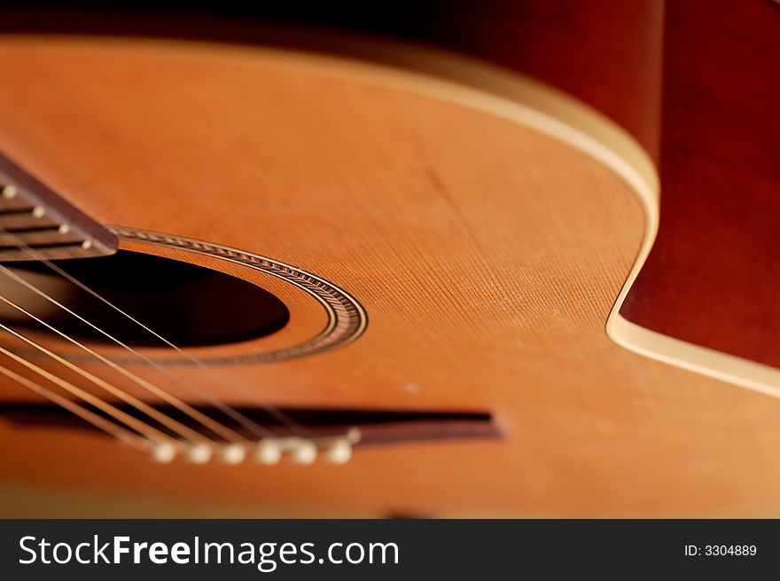 Closeup details of an acoustic wooden guitar