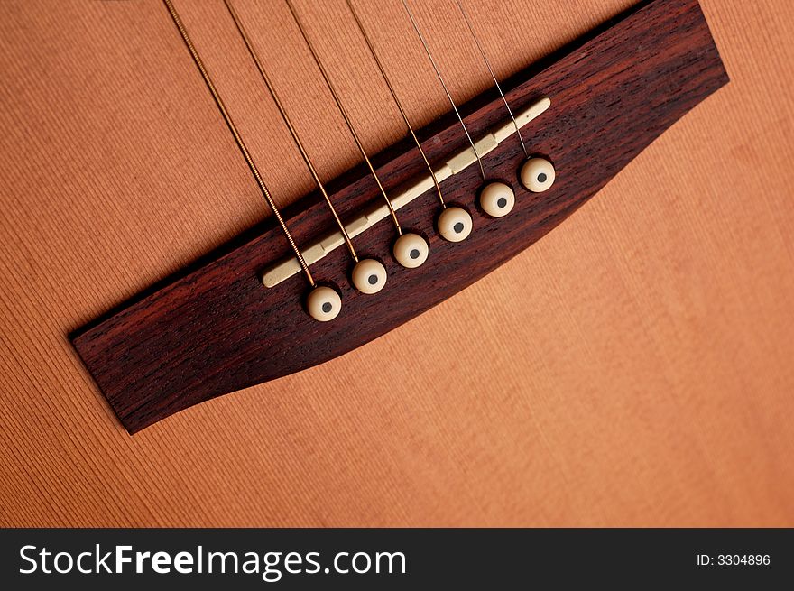 Closeup details of an acoustic wooden guitar