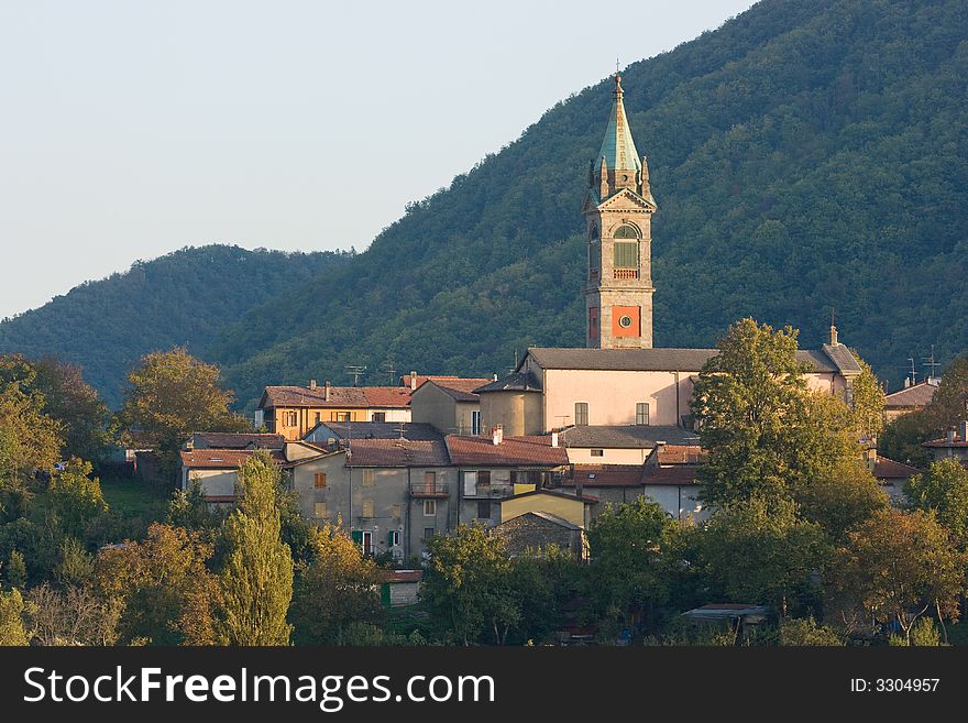Sunset in italian Apennines with church and anciennt houses (Baragazza, municipality of Castiglione dei Pepoli). Sunset in italian Apennines with church and anciennt houses (Baragazza, municipality of Castiglione dei Pepoli)