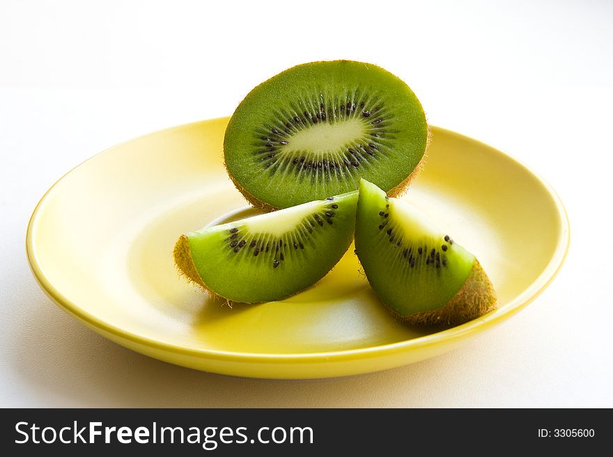 Kiwi on yellow plate. white background