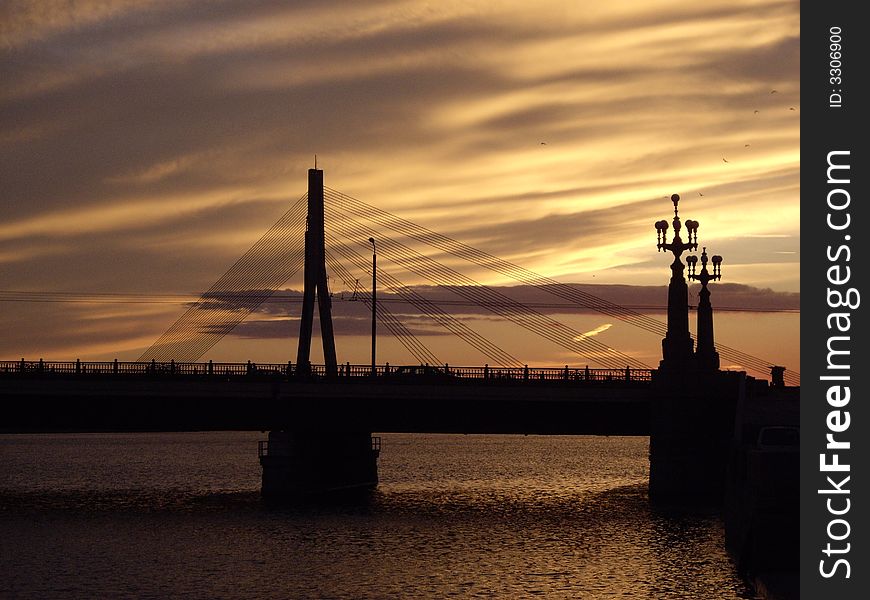 Bridge over the river Daugava in Riga in the time of sunset. Bridge over the river Daugava in Riga in the time of sunset