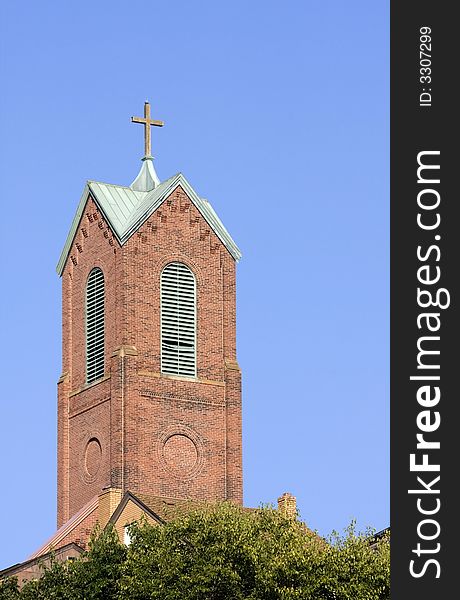 A church tower with a blue sky background. A church tower with a blue sky background