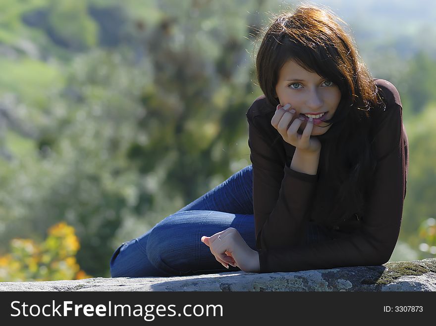 Smiling girl on a rock. Smiling girl on a rock