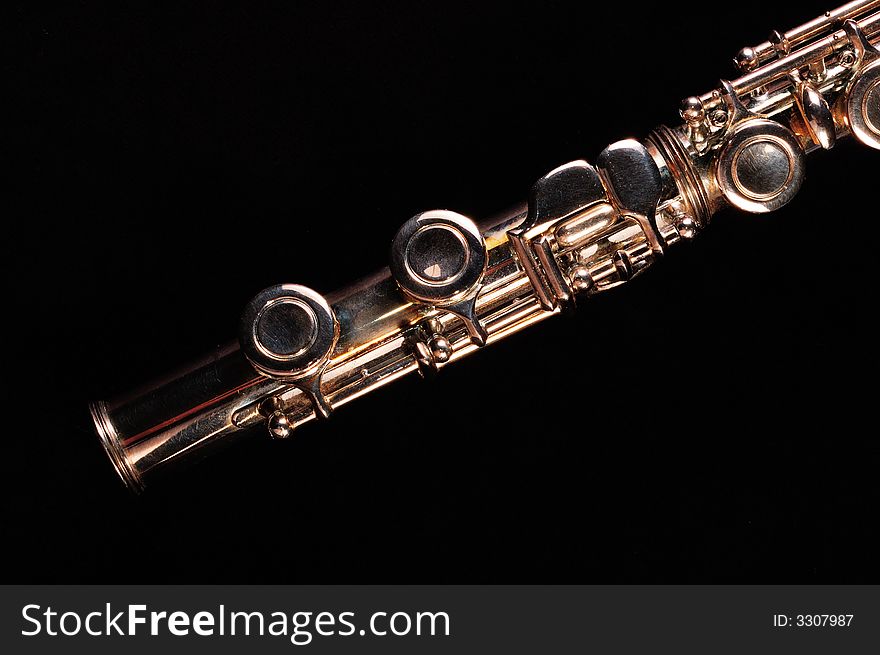 Detail of a Western concert flute, black background. Detail of a Western concert flute, black background