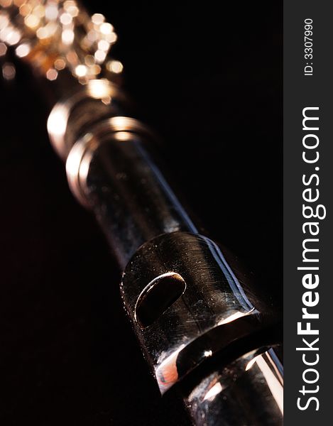 Detail of a Western concert flute, black background. Detail of a Western concert flute, black background