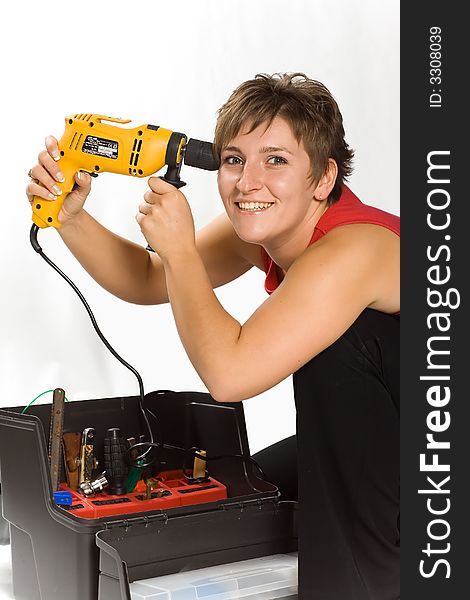 Portrait of young brunette holding the drill. Portrait of young brunette holding the drill