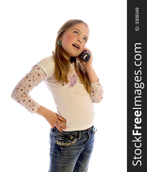 A young girl with long hair stands and listens to a phone conversation. White background. A young girl with long hair stands and listens to a phone conversation. White background.