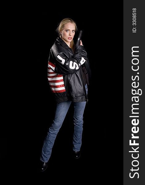 Woman in a leather jacket with USA flag on back, USA on arms and a gun in her hand. Woman in a leather jacket with USA flag on back, USA on arms and a gun in her hand