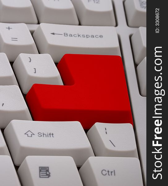 A computer keyboard with a red  key. A computer keyboard with a red  key