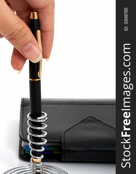 A pen and an organizer over a white background