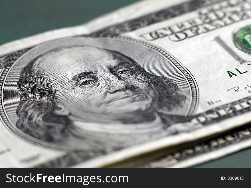 Closeup of hundred dollar bill isolated on background. Closeup of hundred dollar bill isolated on background