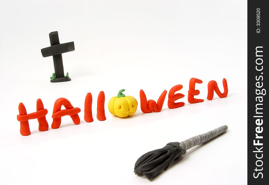 Halloween insrcription from the plasticine with cross and broom. Halloween insrcription from the plasticine with cross and broom