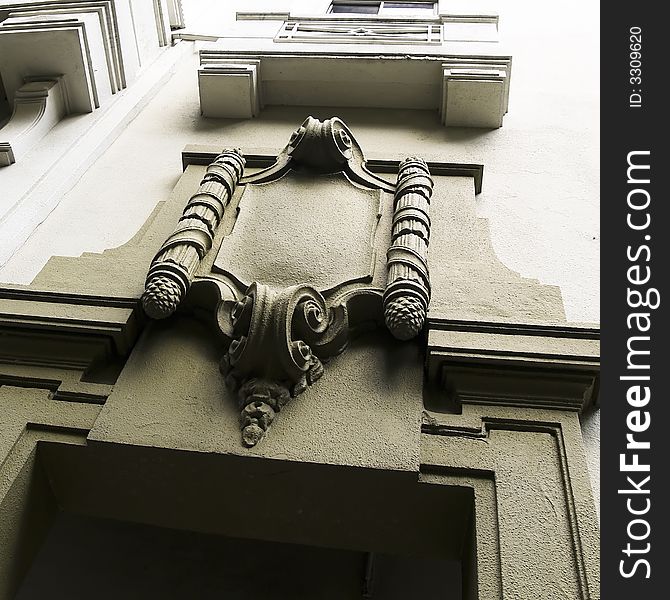 Empty area of shield sculpture for coat of arms atop a doorway in a colonial building in a city's financial district. Empty area of shield sculpture for coat of arms atop a doorway in a colonial building in a city's financial district.