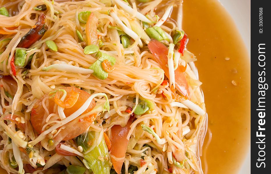 Papaya salad on white dish