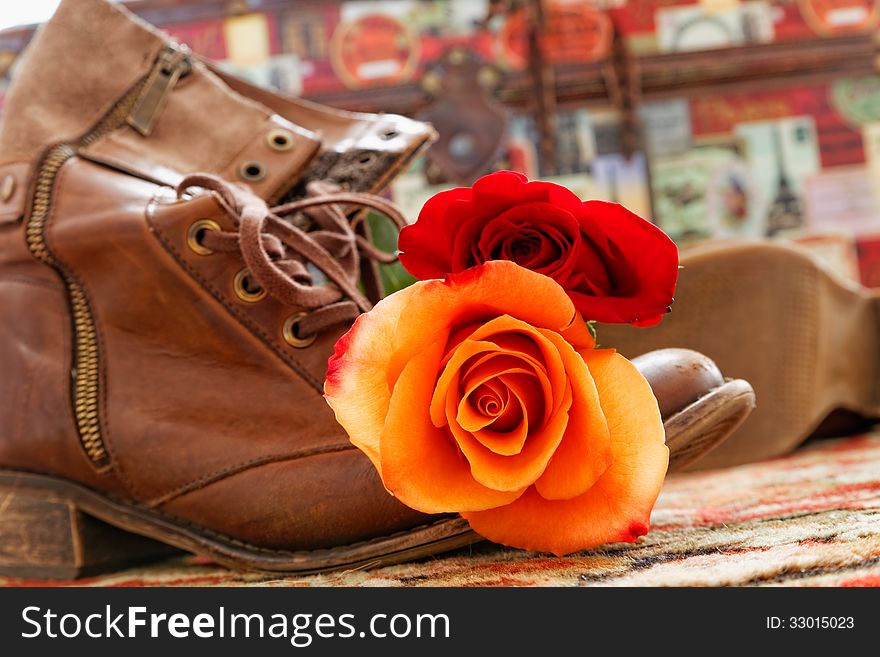 Rose on the old shoes with a travel box in the background. Rose on the old shoes with a travel box in the background