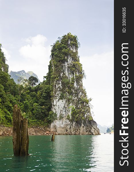 Beautiful high mountains and green river in the morning at Ratchaprapha Dam, Khao Sok National Park, Surat Thani Province, Thailand ( Guilin of Thailand ). Beautiful high mountains and green river in the morning at Ratchaprapha Dam, Khao Sok National Park, Surat Thani Province, Thailand ( Guilin of Thailand )